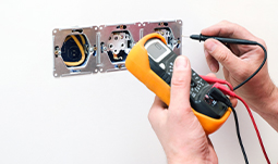Professional Electrician Performing Electrical Repairs at Residential Property