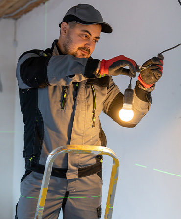 Professional Electrician Installing LED Lighting and Ceiling Lights